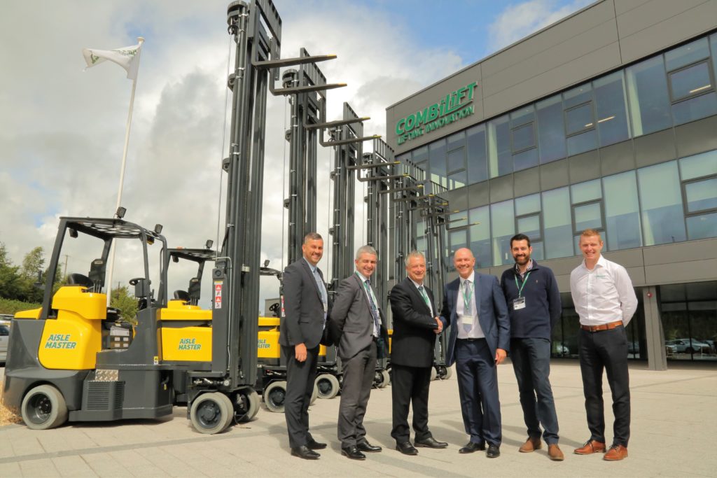 Six Aisle Master Order Pickers outside Combilifts Headquarters with 6 employees from both Combilift and Eddie Stobart Transport standing at the forefront