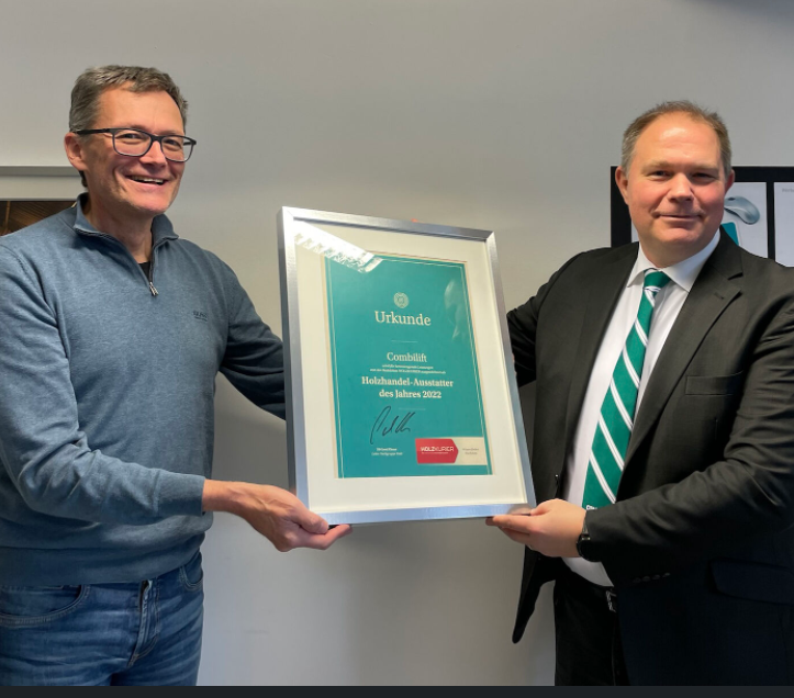 Featured in this photo Gregor Kramar – Country Manager Austria for Combilift & Gerd Ebner, chief editor of Holzkurier, holding the Timber Supplier of the Year 2022 Award