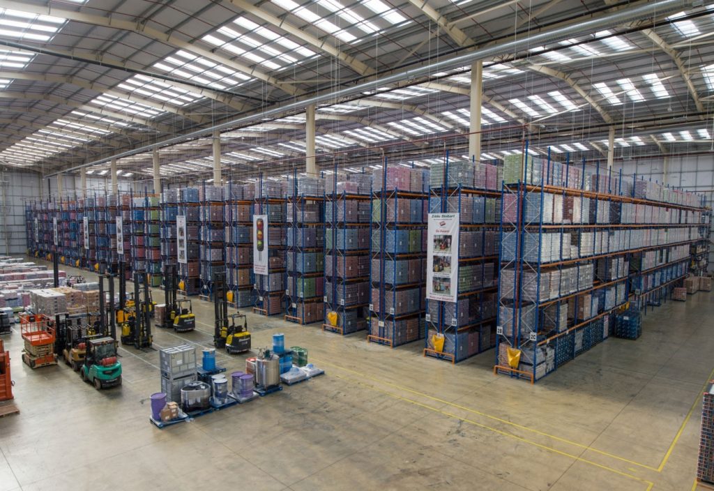Eddie Stobart Warehouse with several Combilift Aisle Master Forklifts and several rows of high stacked palettes